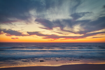 Fototapeta na wymiar the moment after a beautiful sunset over a beach with pink clouds, Atlantic Ocean, Morocco, Tanger