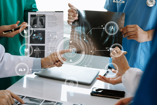 Medical technology network team meeting concept. Doctor hand working with smart phone modern digital tablet and laptop computer with graphics chart interface, with virtual icon .