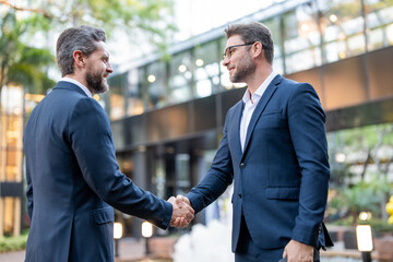 Handshake with business partner in the city for greeting. Handshake between two business men. Two...