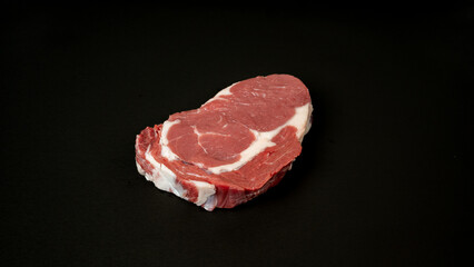 Cut of raw meat beef on black background
