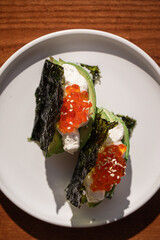 Portion of japanese hand rolls with caviar and avocado