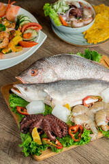 Fresh raw fish decorated with shrimps and fresh lettuce