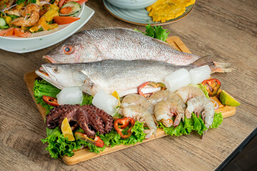 Fresh raw fish decorated with shrimps and fresh lettuce