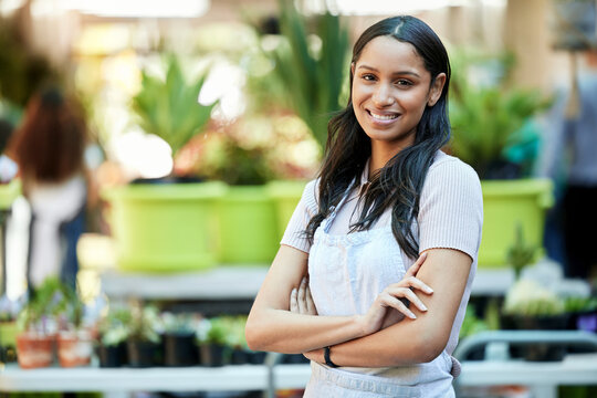 Smile, arms crossed and portrait of woman in garden or nursery as a business owner or employee. Spring, plant expert and a worker at an ecology shop in a park with mockup space for retail or service
