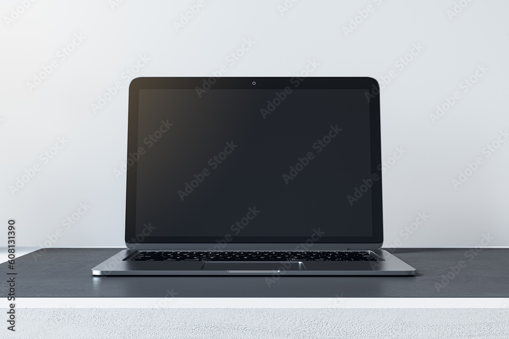 Poster close up of empty mock up laptop screen on desktop and concrete wall background. designer desktop an