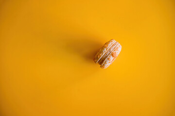 Artistic Composition: Sideways Almond Macaroon on Colorful Yellow Background