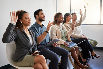 Seminar, workshop and business people in an office with questions in training at work. Happy, team and group of employees sitting in a line at an agency with a vote, volunteering or recruitment