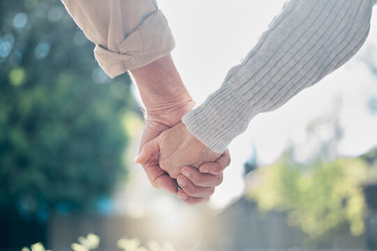 Senior Couple, Holding Hands And Love In Support, Care Or Relationship In Nature Garden Or Park Outdoors. Hand Of Elderly Man And Woman Touching In Loving Romance, Trust Or Partnership Together