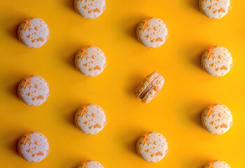 pattern of almond macaroons on a bright yellow background