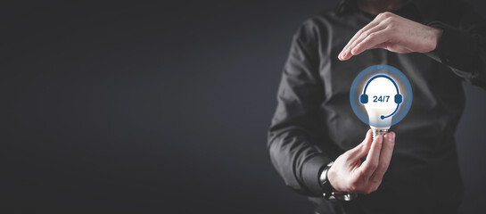 Human showing 24 7 service sign.