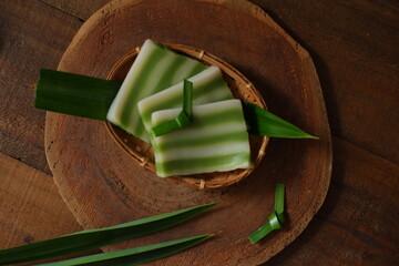 kue lapis in wooden background 