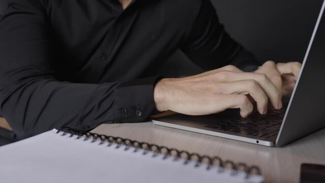 A man patiently waits while engrossed in his work, focused and dedicated to the task at hand