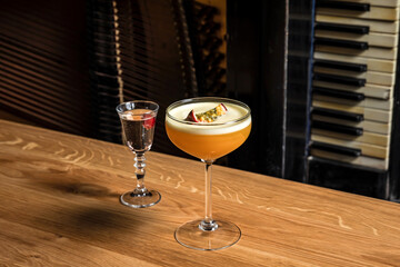Porn star martini cocktail with passion fruit and vodka at the wooden table at bar or restaurant