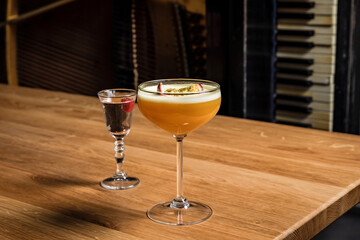 Porn star martini cocktail with passion fruit and vodka at the wooden table at bar or restaurant