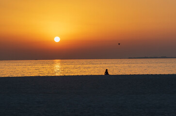 Silhouette of a girl in the beach during sunset. Outdoors