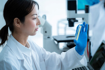 A young Asian female researcher takes her work seriously at the institute