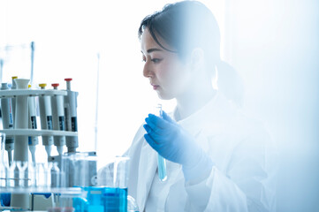 A young Asian female researcher takes her work seriously at the institute