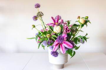 Flowers from a home garden in a vase on a white background.