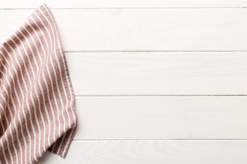 top view with red empty kitchen napkin isolated on table background. Folded cloth for mockup with...