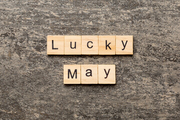 lucky May word written on wood block. Happy May text on table, concept