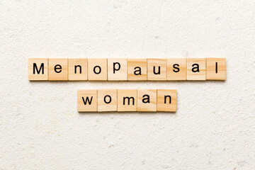 menopausal woman word written on wood block. menopausal woman text on cement table for your desing, concept