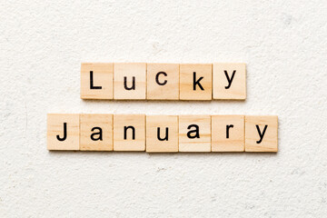 lucky january word written on wood block. lucky january text on table, concept