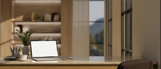 Home workspace with laptop mockup on a table in modern luxury working room.