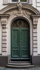Fototapeta na wymiar Vintage green wooden entrance door on the facade of the building, AI generated
