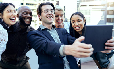 Obraz premium Tablet, selfie and happy business people in city for team building or having fun. Group smile, technology and employees take photo outdoor for social media, profile picture or friends memory online.