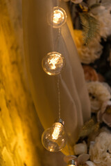 close up of lamp in the loft interior, flowers in the background. lighting, soft warm light