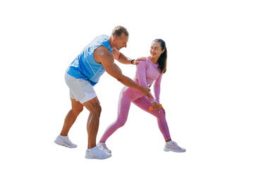 Fototapeta na wymiar Handsome caucasian trainer explains how to do exercise to female client against transparent background. Brunette woman training with dumbbells, smiles satisfied by workout. Personal trainer