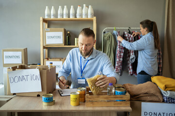 Group of two volunteers working at distribution or refugee assistance center