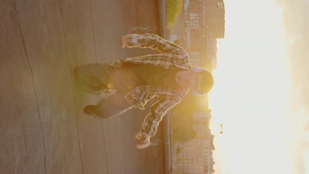 Hip Hop Vibes: Handsome Dancers Portrait in Sunset on Rooftop, Grooving to the Beats with Headphones. Vertical Video. Sunset