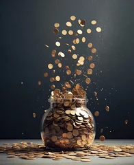 Fotobehang Falling coins into a glass jar with coins on the table. © Andreas