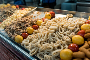 traditional spanish squid rings and fried calamari display in a traditional food stall. Classic spanish tapas known as 
