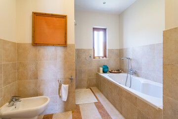 Bathroom with washbasin and large bathtub for relaxation in the hotel.