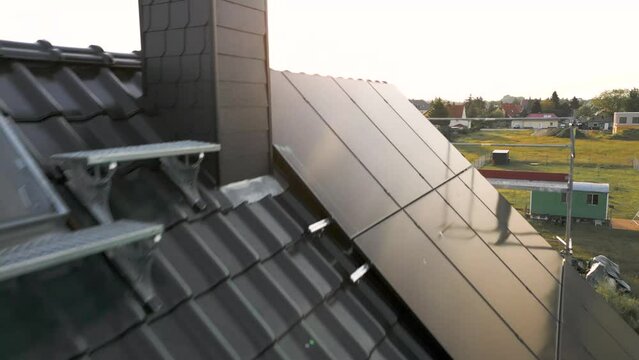 Flight over the roof of a detached house showing newly installed solar panels