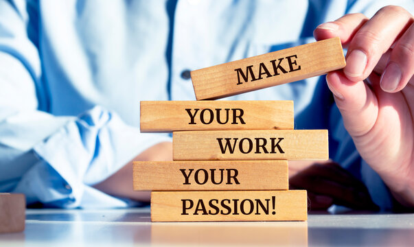 Close up on a businessman holding a wooden block with a "Make your work your passion" message