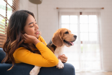 On weekends, a beagle and her owner sit in their living room,