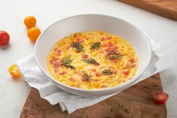 Portion of gourmet tender omelette with ham and dill