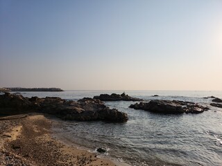 Sea foam on the shore with yellow sand. Ocean shore. Sand and wave background.