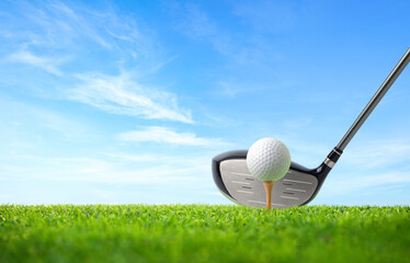 Golf ball on tee and driver golf club with blue sky background. - obrazy, fototapety, plakaty
