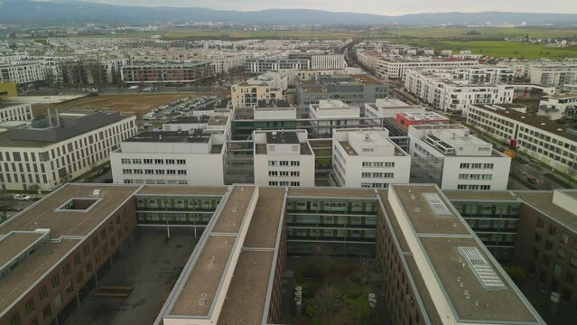 Fly above Goethe University campus. Complex of modern multistorey buildings on city outskirts. Frankfurt am Main, Germany