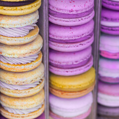 Pattern of delicious sweet french pastry. Colorful macaroons display in candy shop. Purple, violet, pink, yellow  bakery