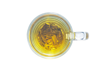 Green tea in a transparent glass cup. View from above. On a white background.