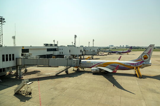 Bangkok Thailand - May 19, 2023 ; Nok Air's airplane, a popular low-cost airline in Thailand, is parked at Don Mueang International Airport, ready to transport passengers on a clear and sunny day.
