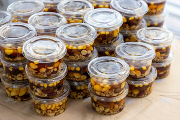 Cold Assorted beans in syrup is a delightful dessert made by combining a variety of beans with a sweet syrup and serving it chilled. Packed in plastic cups ready to serve.