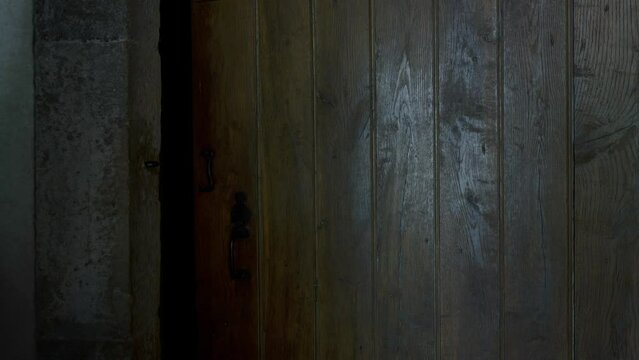 Antique wooden door opens into darkness. halloween concept
