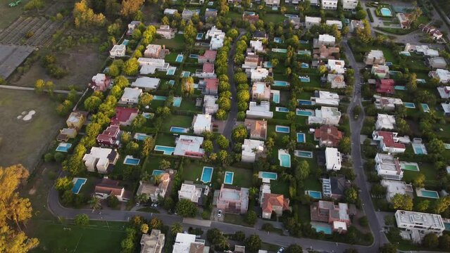 Luxury houses with private pools in residential neighborhood in north area of Buenos Aires, Argentina. Aerial top-down orbiting