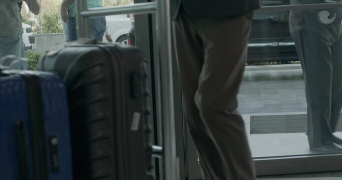 A porter carries the suitcases of guests on a trolley in an expensive luxury hotel